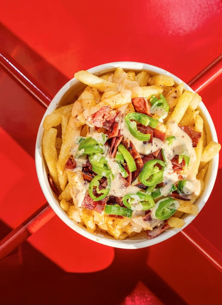 SLCTD loaded fries with cheese sauce, turkey bacon and jalapeños